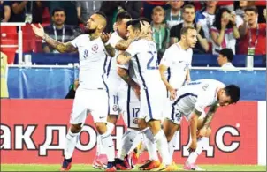  ?? KIRILL KUDRYAVTSE­V/AFP ?? Chile players celebrate a goal as it is ruled offside by video assistant referees during their Confederat­ions Cup match against Cameroon on Sunday.