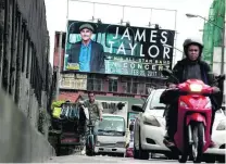  ?? Noel Celis / AFP ?? A billboard in Manila promotes James Taylor’s concert. The singer has voiced concern over Rodrigo Duterte’s policy.