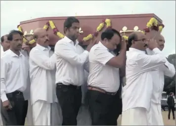  ??  ?? Mourners wear white during a funeral procession. BELOW: The member of the family, who undertakes to perform the last rites, should have his head shaved.