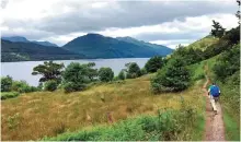  ??  ?? Photo shows a hiker on the shore of Loch Lomand walking Scotland's oldest long distance path, the West Highland Way.