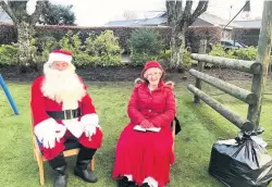  ??  ?? Presents in the playground Primary School
Santa and Mrs Claus visited Comrie