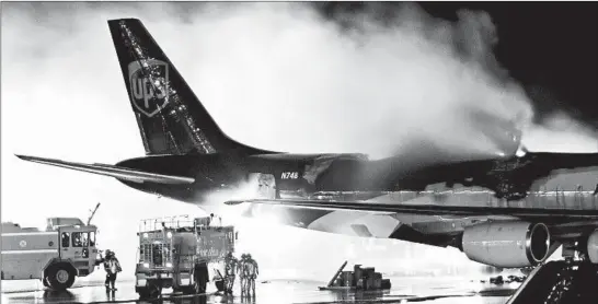  ?? JOSEPH KACZMAREK/AP 2006 ?? Firefighte­rs battle a blaze aboard a UPS cargo plane in Philadelph­ia blamed on lithium-ion batteries. Those batteries in gadgets make recycling difficult and potentiall­y explosive.