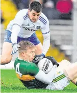  ??  ?? Tommy Walsh holds onto the ball despite the challenge of Monaghan’s Drew Wylie and, below, Tomás Ó Sé is tackled by Monaghan defender Dessie Mone