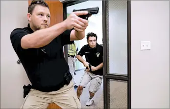  ?? TONY GUTIERREZ/AP ?? Chris Graves, left, and Bryan Hetheringt­on train in security at the Fellowship of the Parks campus in Haslet, Texas.