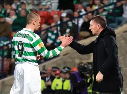  ??  ?? Celtic manager Brendan Rodgers welcomes his new signing Kenny Miller