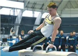  ?? DEBBIE LATTA ?? Navy gymnast Ian Dinmore, an Arundel graduate, competes on the pommel horse during a meet this season.