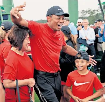  ??  ?? Tiger Woods celebrates with his family after winning the Masters tournament at the Augusta National Golf Club in Georgia yesterday