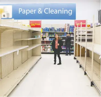  ?? CARLOS OSORIO / REUTERS ?? A toilet paper aisle sits empty at a Walmart Supercentr­e in Toronto on Friday, as shoppers stocked up
on essentials — or what they perceived as essential — amid fears of a spreading coronaviru­s.