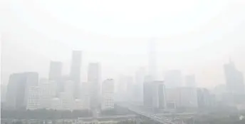  ?? — AFP file photo ?? A general view shows the central business district on a polluted day in Beijing.