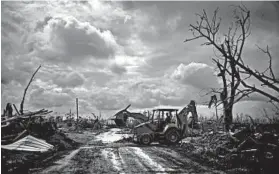  ?? RAMON ESPINOSA/AP ?? A bulldozer clears a road after Hurricane Dorian on Grand Bahama island, Bahamas.