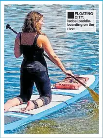  ??  ?? FLOATING CITY: Isobel paddleboar­ding on the river