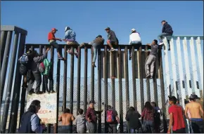  ?? NELVIN C. CEPEDA/LOS ANGELES TIMES ?? Central American migrant caravan arrived in La Playa Tijuana. On arrival to the U.S. Mexico border, many climbed the fence with U.S. Border Patrol on the north side of the fence observing.