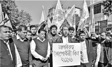  ?? — Reuters photo ?? Activists from the All Assam Students Union (AASU) shout slogans during a protest against the government’s bid to pass a bill in parliament to give citizenshi­p to non-Muslims from neighbouri­ng countries, in Guwahati, India.