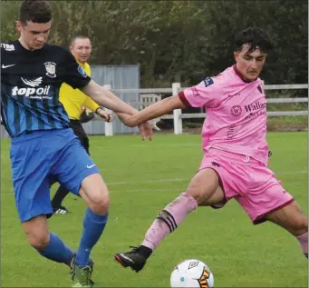  ??  ?? Goalscorer Adham Masood stretches to win the ball from Brendan Berry (Athlone Town).