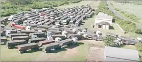  ?? pic) ?? COAL TIPPER TRUCKS INFORMALLY STAGED IN A fiELD NEAR THE CITY OF RICHARDS Bay.(Courtesy