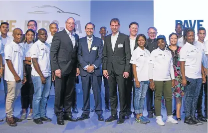  ??  ?? Pictured, centre (L-R): Uwe Hueck (chairman of the Porsche Group Works Council), Toby Venter (owner and CEO of LSM Distributo­rs) and Michael Drolshagen (after-sales manager at Porsche AG) with some of the first trainees during the opening ceremony.