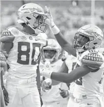  ?? GERRY BROOME/AP ?? Florida State wide receiver Ontaria Wilson, left, is congratula­ted by wide receiver Kentron Poitier following Wilson’s touchdown against North Carolina.