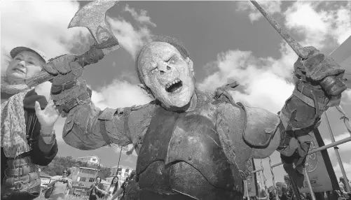  ?? HAGEN HOPKINS/ GETTY IMAGES FILES ?? A New Zealand fan in orc costume at the debut screening of The Hobbit, a short novel that’s being adapted into three feature films.