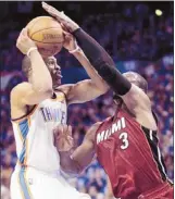  ?? Jeff Roberson Associated Press ?? Thunder guard Russell Westbrook finished with 27 points, 11 assists and eight rebounds in Tuesday’s victory over Dwyane Wade and the Miami Heat in the opening game of the NBA finals.