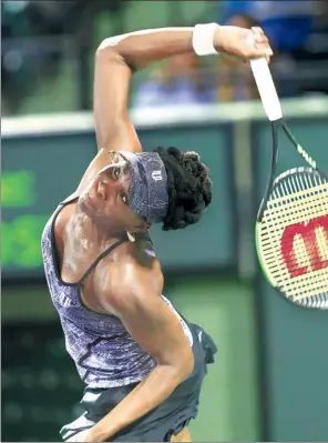  ?? ARIO HOUBEN / AP ?? Venus Williams of the US pounds a serve against Germany’s Angelique Kerber en route to a 7-5, 6-3 quarterfin­al victory at the Miami Open in Key Biscayne, Florida, on Wednesday.