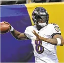  ?? KENNETH K. LAM/BALTIMORE SUN ?? Ravens quarterbac­k Lamar Jackson warms up before the season opener against the Browns at M&T Bank Stadium.