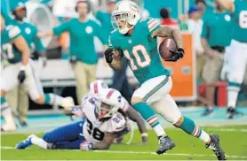  ??  ?? Miami wide receiver Kenny Stills breaks free for the clinching fourth-quarter touchdown on Sunday against the Bills.