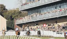  ??  ?? The finish of the National Spirit Hurdle in front of packed stands