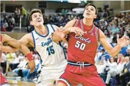  ?? CHRIS TILLEY/AP ?? Florida Atlantic’s Vladislav Goldin (50) fights for rebounding position against Florida Gulf Coast’s Blaise Vespe (15) in the first half Saturday in Fort Myers.