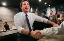  ?? Spencer Platt/Getty Images ?? Democratic presidenti­al hopeful Pete Buttigieg greets supporters at a pizzeria Tuesday morning after the flawed Iowa caucus in Manchester, N.H.