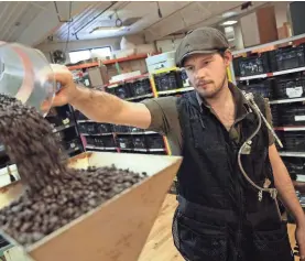  ?? USA TODAY NETWORK ?? Benjamin Lisser of Just Coffee Cooperativ­e in Madison, Wis., wears a vest that measures dangerous compounds in the air.