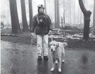  ?? AP PHOTO/KATHLEEN RONAYNE ?? Eric Darling and his dog Wyatt search a mobile home park after the deadly Camp Fire in Paradise, Calif., on Friday. The team from Southern California completed a second search because of reports of missing people whose last known address was at the mobile home park.