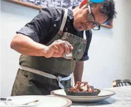 ?? PHOTOS BY ANTRANIK TAVITIAN/THE REPUBLIC ?? Chef Carlos Diaz plates his bread pudding dish at Otro Cafe on May 5.