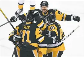  ?? Peter Diana/Post-Gazette ?? Penguins’ Sidney Crosby celebrates after Evgeni Malkin scores Monday in the first period against the Nashville Predators at PPG Paints Arena.