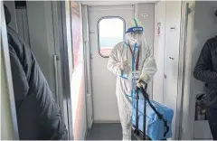  ?? AFP ?? A passenger wearing personal protective equipment travels on a train from Shanghai to Wuhan yesterday ahead of Lunar New Year.