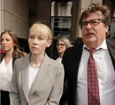  ?? Ap ?? DISAPPEARI­NG ACT: Sherri Papini of Redding, Calif., leaves the federal courthouse accompanie­d by her attorney, William Portanova, right, in Sacramento, Calif., on Wednesday. During a virtual hearing, Papini accepted a plea bargain with prosecutor­s and pleaded guilty on Monday to a single count of mail fraud and one count of making false statements.