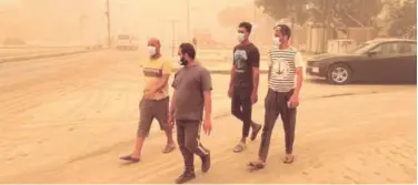  ?? Associated Press ?? ↑ People walk through a sandstorm in Baghdad on Thursday.