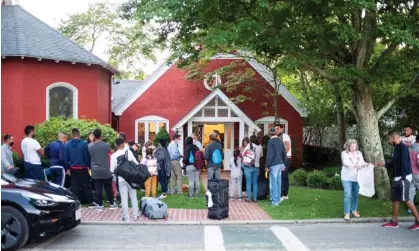  ?? Photograph: Ray Ewing/Vineyard Gazette/Reuters ?? Venezuelan migrants stand outside St Andrew's Church in Edgartown, Massachuse­tts, on 14 September.