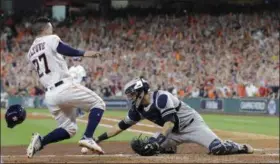  ?? DAVID J. PHILLIP — THE ASSOCIATED PRESS ?? The Astros’ Jose Altuve scores the game-winning run past Yankees catcher Gary Sanchez during the ninth inning of Game 2 of the American League Championsh­ip Series in Houston.