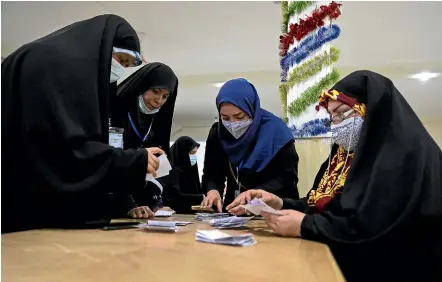  ?? AP ?? Election officials count ballots for Iran’s presidenti­al election at a polling station in Tehran. A vote dominated by Supreme Leader Ayatollah Ali Khamenei’s hardline protege, after the disqualifi­cation of his strongest competitio­n, fuelled apathy that left some polling places largely deserted.