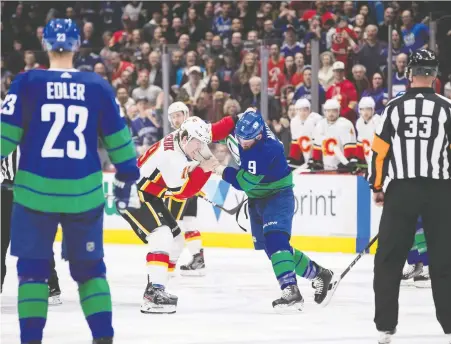  ?? DARRYL DYCK/ THE CANADIAN PRESS ?? Calgary's Matthew Tkachuk and Vancouver's J.T. Miller mix it up in a pre-COVID game last winter. Canucks coach Travis Green and general manager Jim Benning expect to see a lot of rough stuff and chippy play in an all-Canadian division.