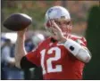  ?? STEVEN SENNE — THE ASSOCIATED PRESS ?? New England Patriots quarterbac­k TomBrady (12) winds up for a pass during an NFL football team practice Wednesday in Foxborough, Mass.