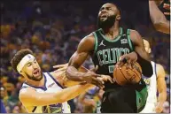  ?? Jed Jacobsohn / Associated Press ?? Boston Celtics guard Jaylen Brown, right, drives to the basket against Golden State Warriors guard Klay Thompson during the first half of Game 5 of the NBA Finals Monday in San Francisco.