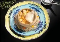 ??  ?? Double-boiled Sea Whelk soup with Fish Maw and Chicken Served in a Whole Coconut