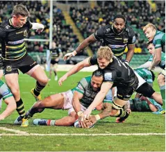  ??  ?? Collision course: Jamie Gibson, of Northampto­n, tackles Newcastle’s Sonatane Takulua