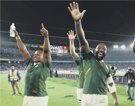  ??  ?? 0 South Africa’s hooker Bongi Mbonambi (L), prop Tendai Mtawarira (C) and flanker Siya Kolisi celebrate reaching the final. Kolisi is the first black player to be appointed Springboks captain.