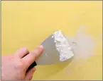  ??  ?? Applying spackle to imperfecti­ons in walls is an important part of the painting process.