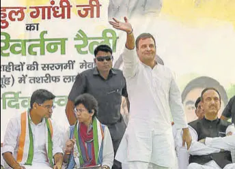  ?? PTI ?? Congress leader Rahul Gandhi waves at his supporters during a rally in support of party candidate Aftab Ahmed in Nuh district on Monday. Haryana Congress president Kumari Selja and senior party leader Ghulam Nabi Azad are also seen.