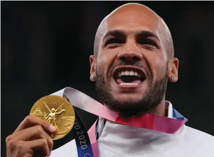  ?? ?? Lamont Marcell Jacobs, of Italy poses with his gold medal following the men's 100‑meters final at the 2020 Summer Olympics, Monday, Aug. 2, 2021, in Tokyo. Track and field is set to become the first sport to introduce prize money at the Olympics, with World Athletics saying Wednesday, April 10, 2024, it would pay $50,000 to gold medalists in Paris. (AP Photo/Francisco Seco, File)