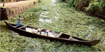  ?? VISHNU PRATHAP ?? People’s plight: Prasad, a resident of Chungathu Muppathu in upper Kuttanad, enters the Kottayam-Alappuzha channel on a country boat with vessels full of drinking water collected from a public tap.