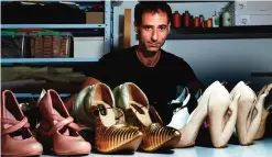  ??  ?? Israeli shoe designer Kobi Levi poses in his workshop with some of his shoe creations.